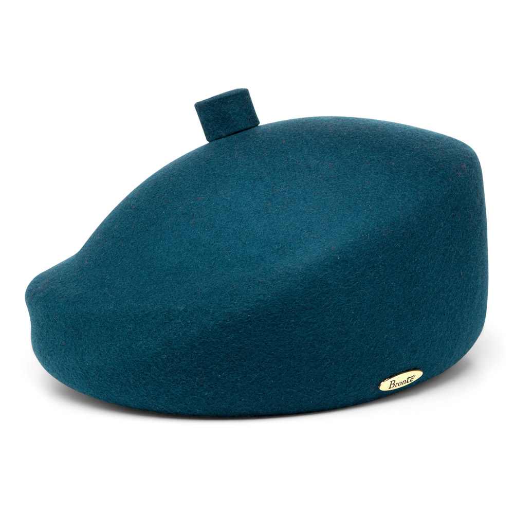 Bronté- MareB is a structured wool beret, with a slight asymmetry in the shape, wear the beret tilted like a french beret, made up in teal green.